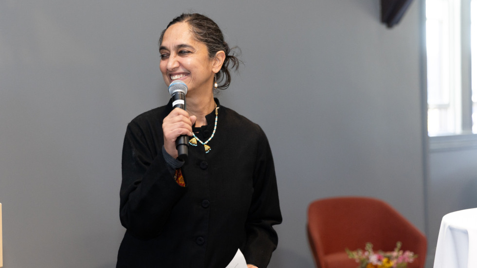 Leela Gandhi speaks into a microphone.