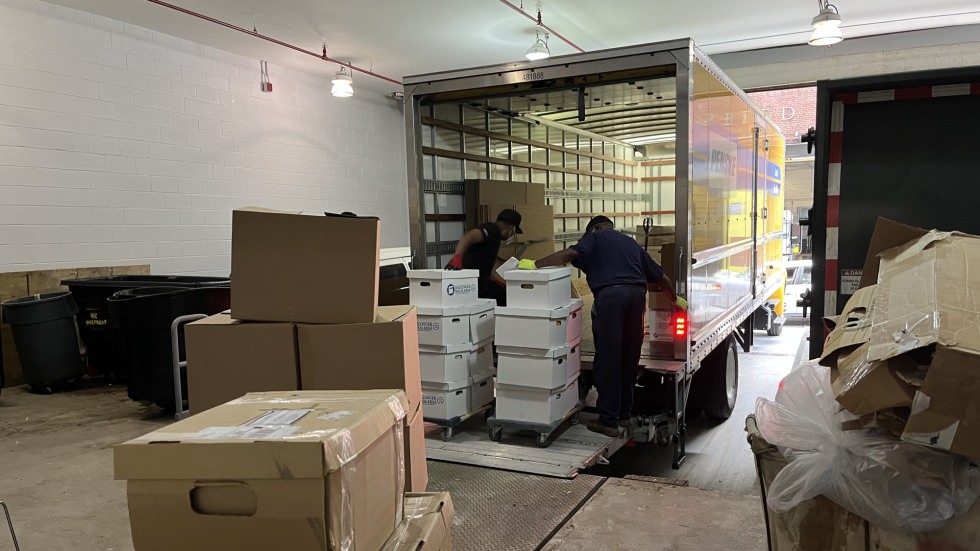 Boxes of collected materials loaded onto a truck for transport from New York City to Providence